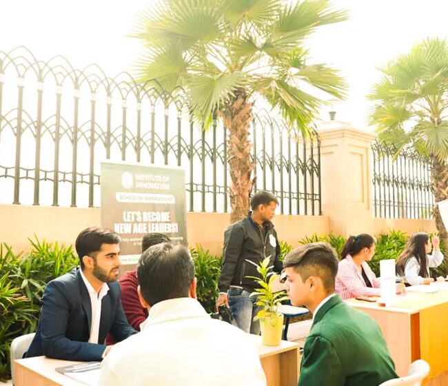 Students talking with counsellors at a career-fair desk