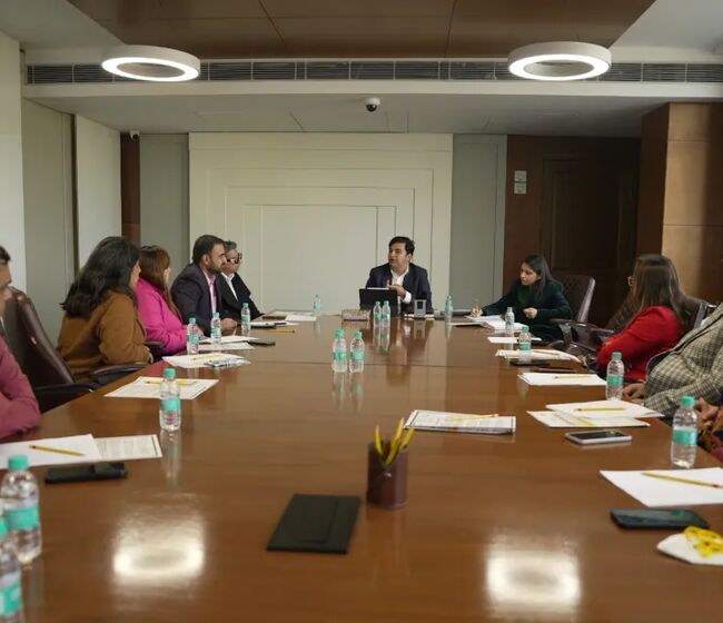 Parents and school leaders in a meeting around a conference table