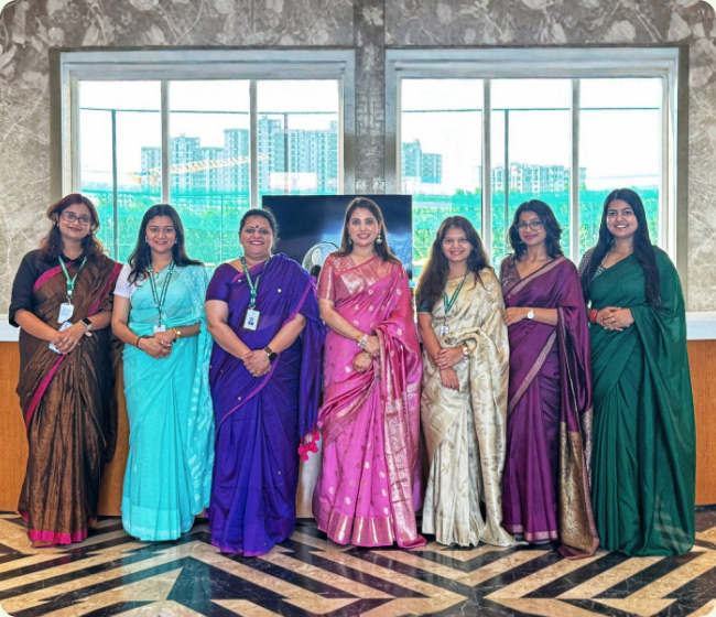 Counsellors from the Well-Being Department in saris in a marble lobby