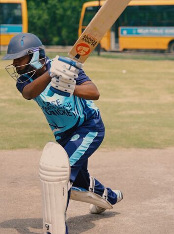 A student batting in a cricket match